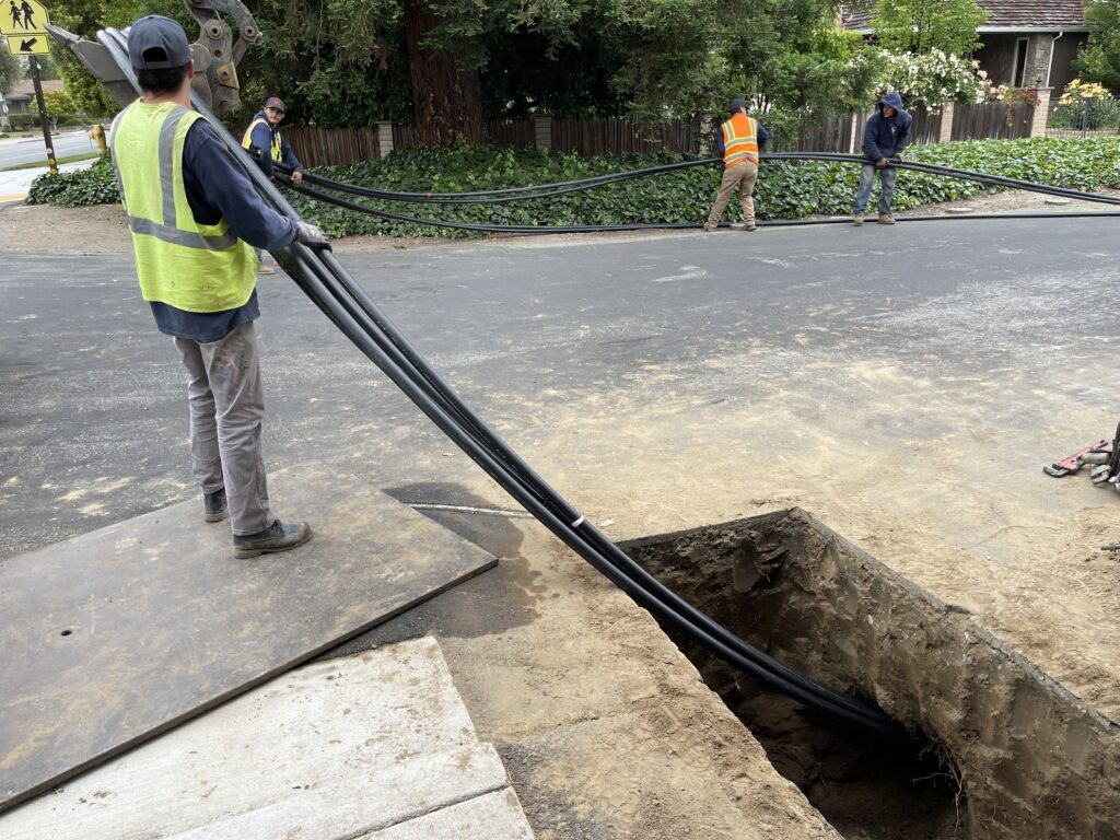 Feeding 4 Pipes into our bore with the Directional Drill Pulling them.